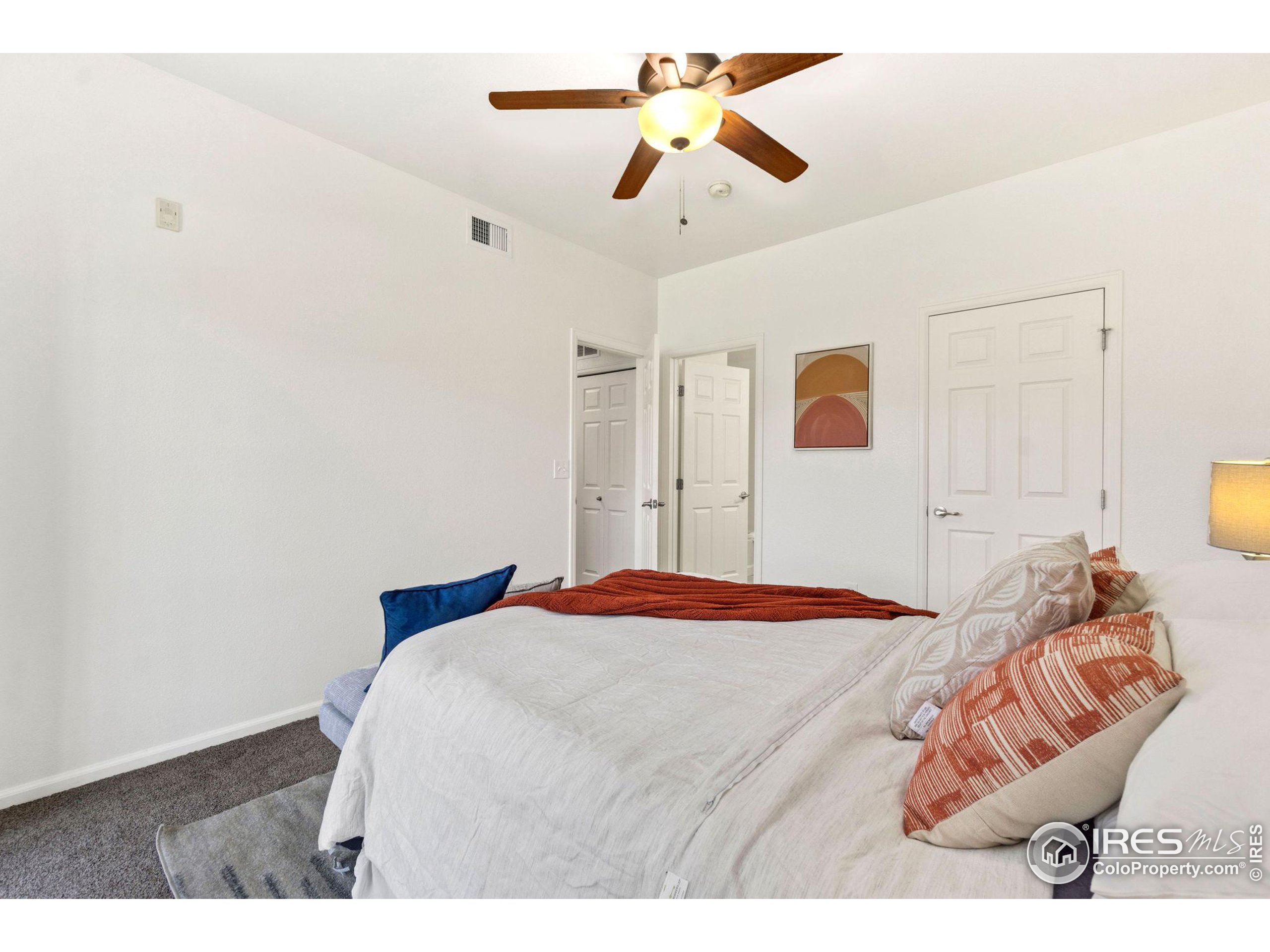 Undisclosed Address Erie, CO 80516 - Photo 7 of 20 a bedroom with a bed and a chandelier