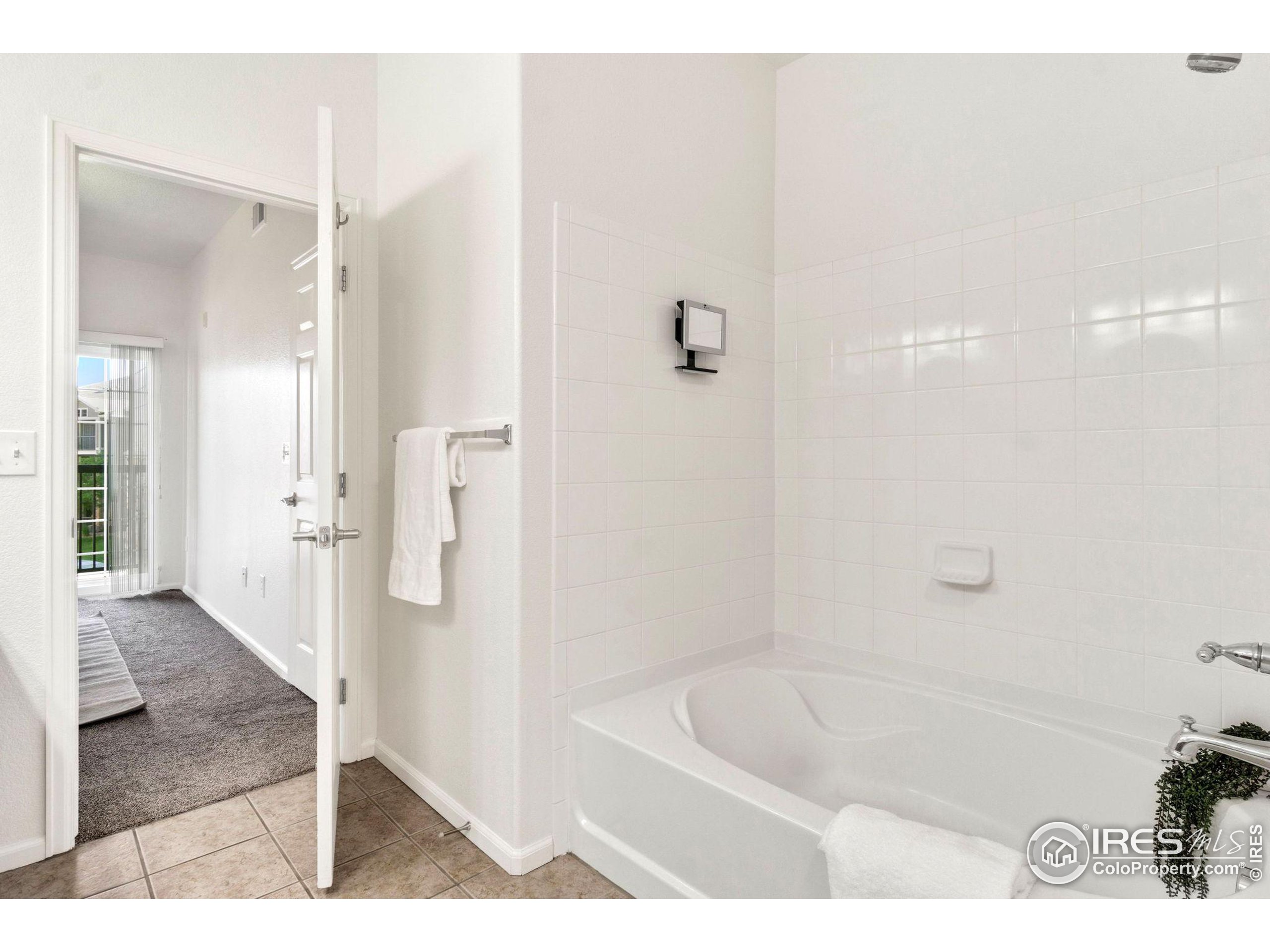 Undisclosed Address Erie, CO 80516 - Photo 9 of 20 a bathroom with a bathtub and a shower