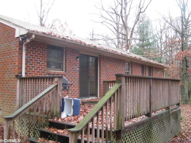 1311 Belle Meade Road Bumpass, VA 23024 - Photo 5 of 5 a view of deck with wooden fence and large trees