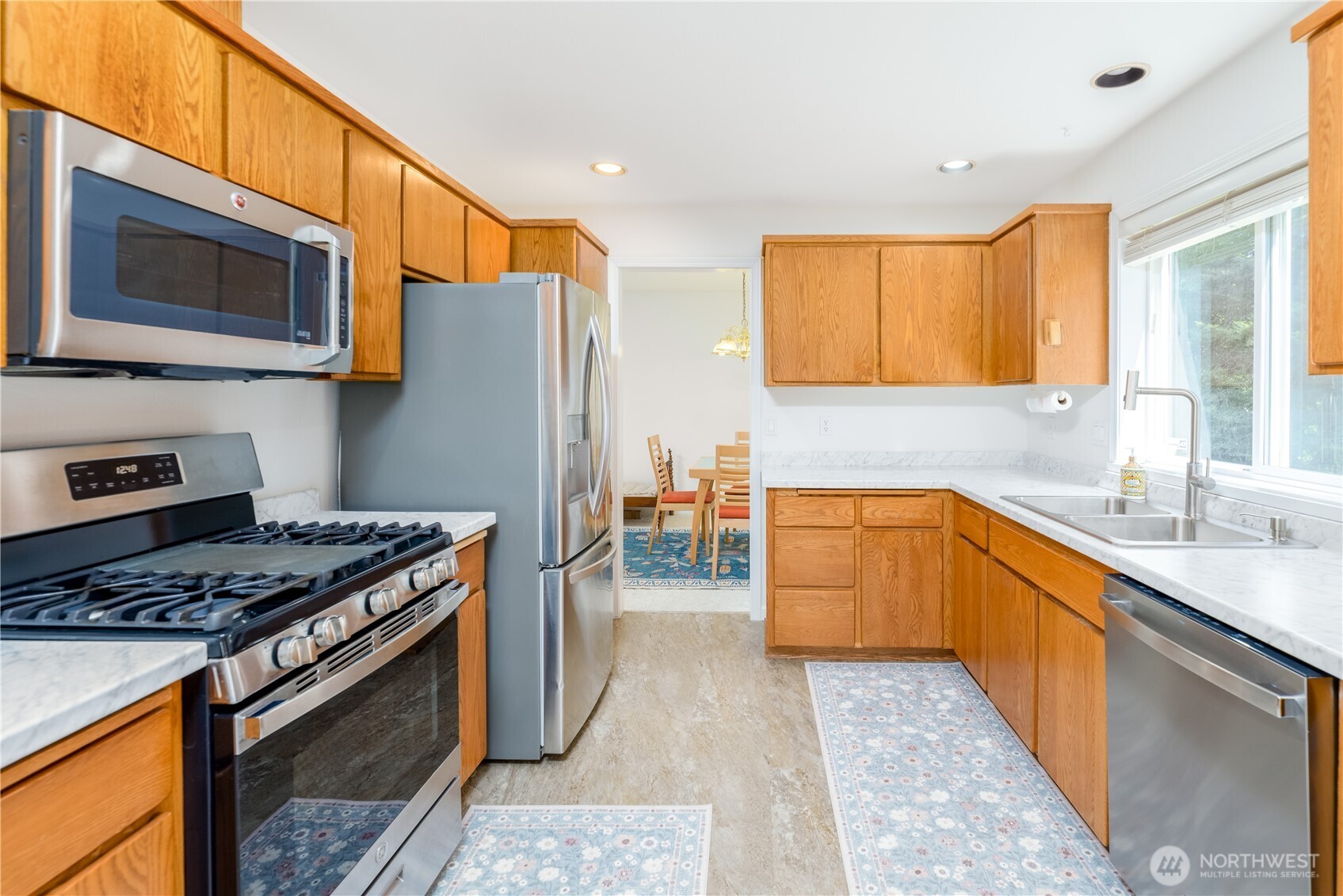 301 Mt Pleasant Estates Road Port Angeles, WA 98362 - Photo 8 of 40 a kitchen with stainless steel appliances granite countertop a stove a sink and a microwave