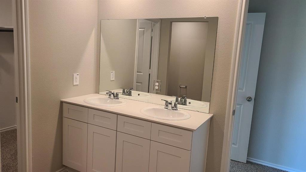 1512 Tin Roof Road Krum, TX 76249 - Photo 6 of 13 a bathroom with a double vanity sink and a mirror