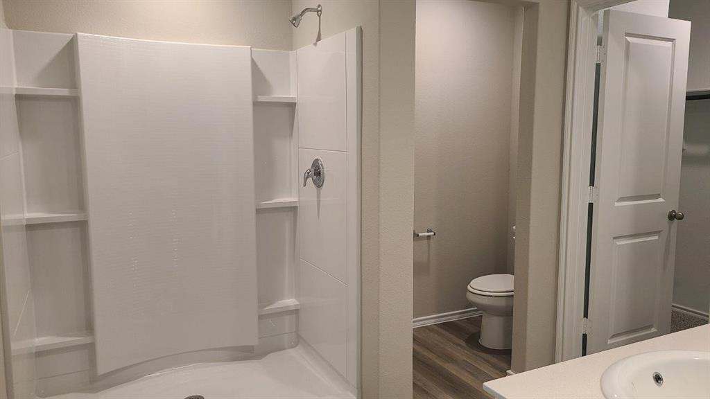 1512 Tin Roof Road Krum, TX 76249 - Photo 7 of 13 a bathroom with a sink a toilet and shower