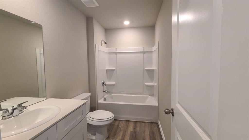 1512 Tin Roof Road Krum, TX 76249 - Photo 9 of 13 a bathroom with a sink a toilet and shower