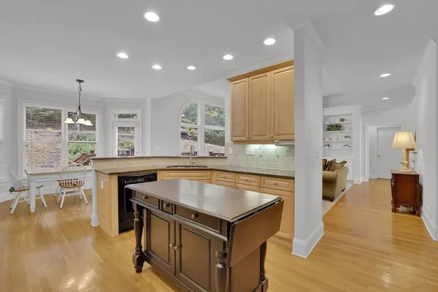 a kitchen with stainless steel appliances granite countertop a refrigerator a stove and a sink