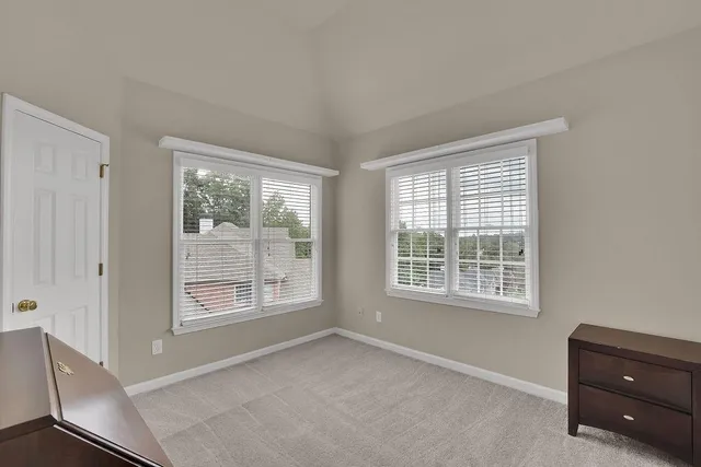 a spacious bathroom with a granite countertop sink and a mirror