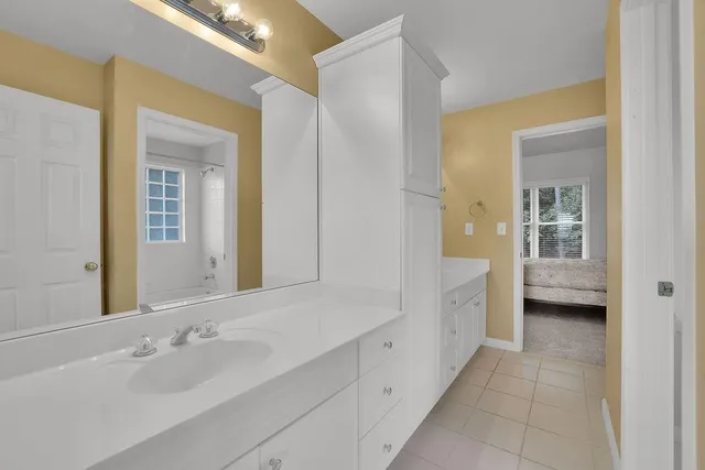 a bed sitting in a room next to a window