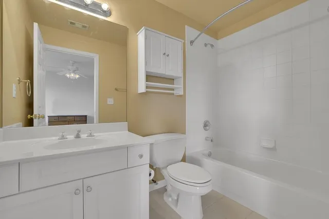 a spacious bedroom with a bed and a window