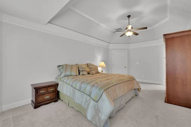 a bed room with a bed and ceiling fan
