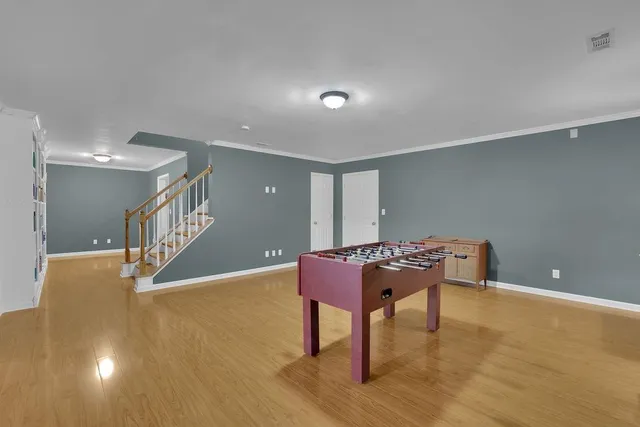 a view of an empty room with window and stairs