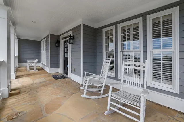 a dining room with furniture a chandelier and wooden floor
