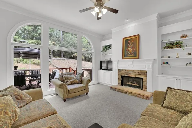 a living room with furniture a flat screen tv and a fireplace