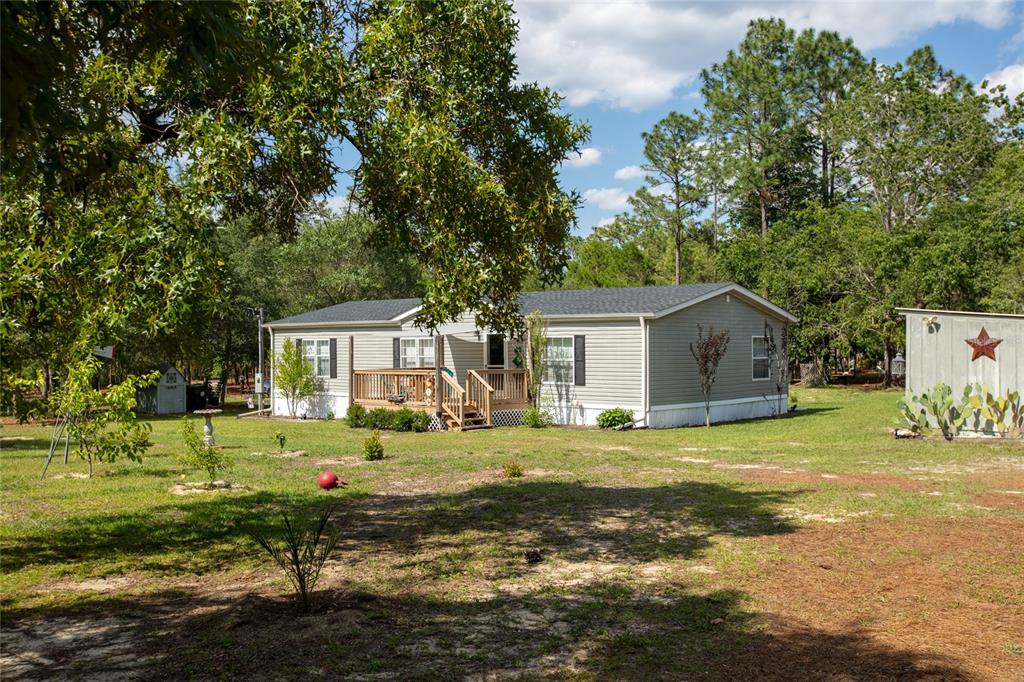 5670 Acadia Street Keystone Heights, FL 32656 - Photo 4 of 65 a front view of a house with a yard