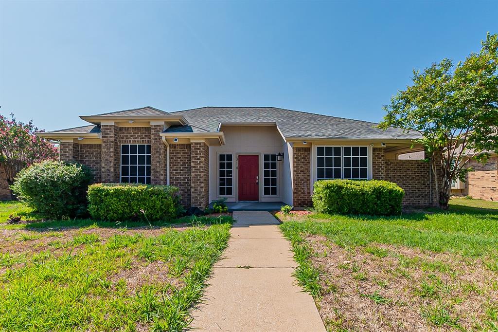 314 Ridgegate Drive Garland, TX 75040 - Photo 1 of 1 a front view of a house with garden