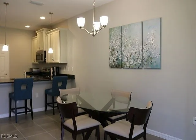 a view of house with swimming pool and outdoor seating