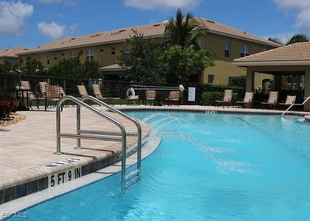 a view of swimming pool with outdoor seating and plants