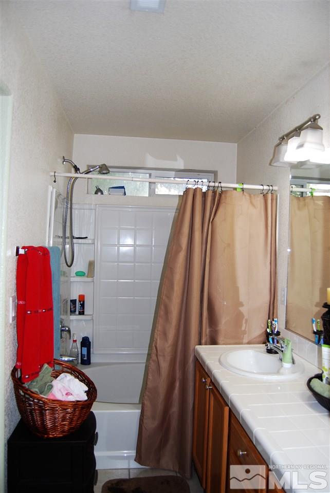 2355 Keystone Avenue Reno, NV 89503 - Photo 11 of 14 a bathroom with a sink and a mirror