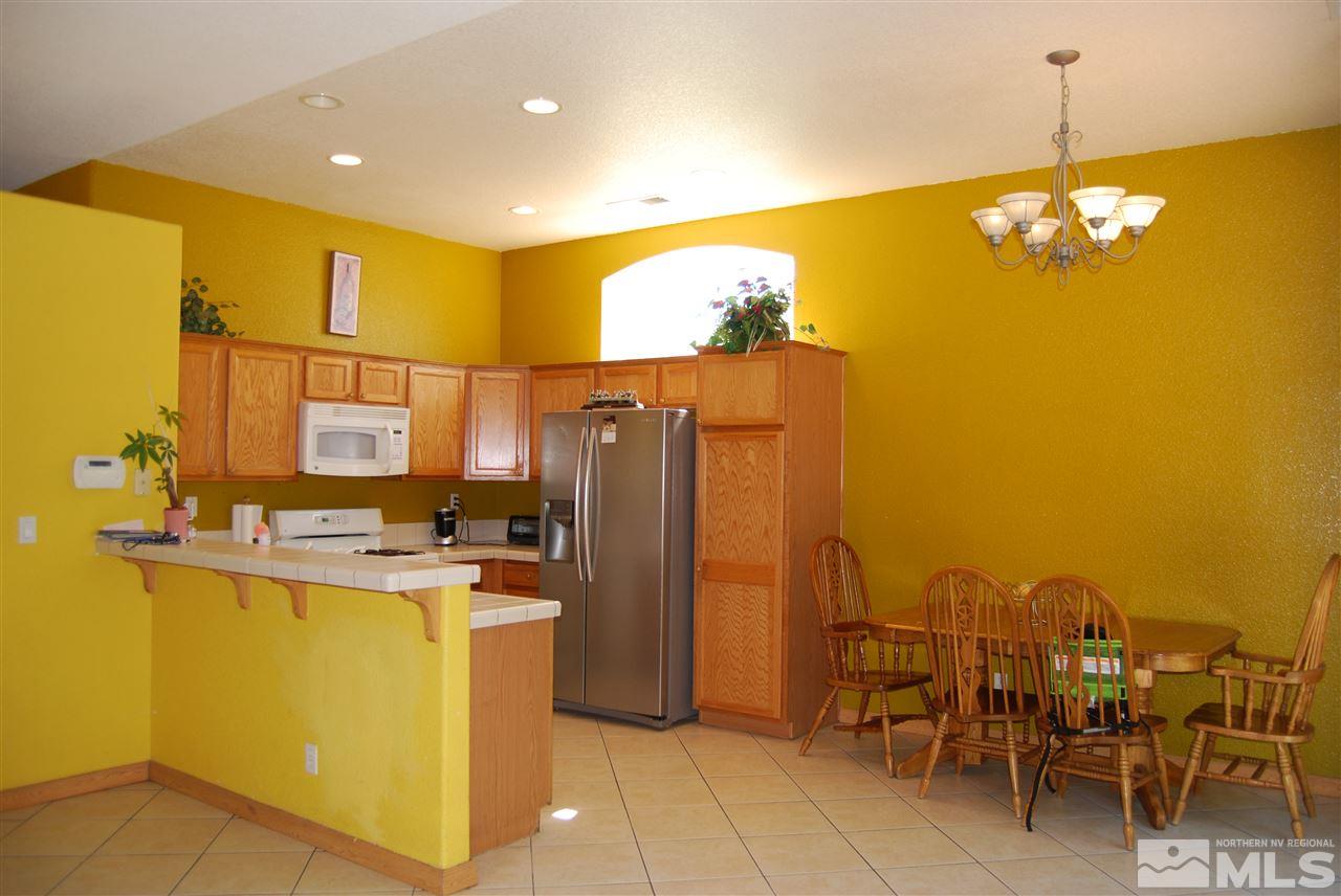 2355 Keystone Avenue Reno, NV 89503 - Photo 5 of 14 a view of a kitchen with kitchen island stainless steel appliances refrigerator stove and furniture