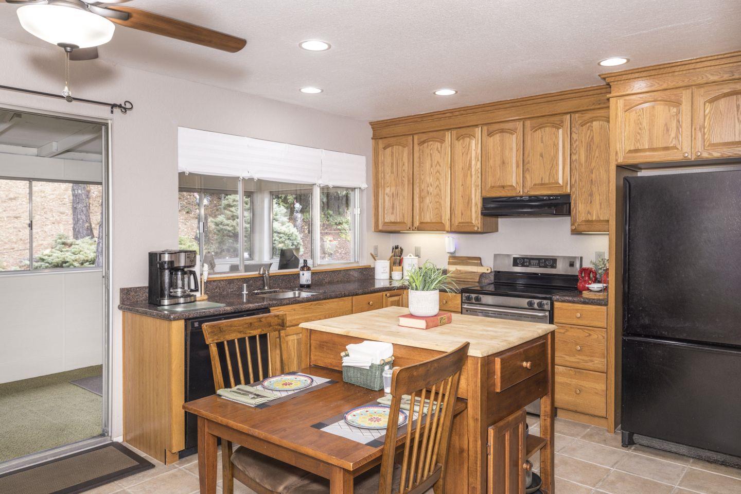 27975 Edgecliff Way Hayward, CA 94542 - Photo 12 of 58 a kitchen with stainless steel appliances granite countertop a stove a refrigerator a sink a dining table and chairs with wooden floor