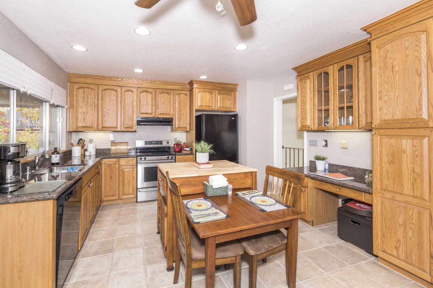 27975 Edgecliff Way Hayward, CA 94542 - Photo 13 of 58 a large kitchen with kitchen island granite countertop a stove a sink a dining table and chairs