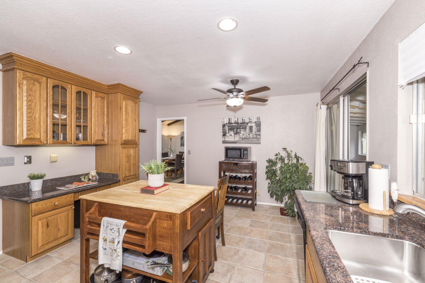 27975 Edgecliff Way Hayward, CA 94542 - Photo 18 of 58 a dining room with a table chairs and a kitchen view