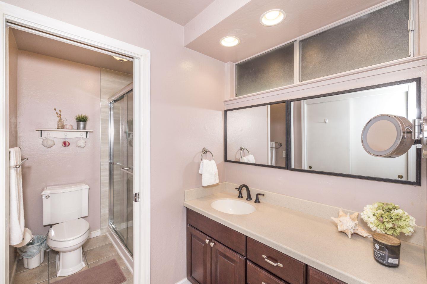27975 Edgecliff Way Hayward, CA 94542 - Photo 28 of 58 a bathroom with a granite countertop sink a toilet and a mirror