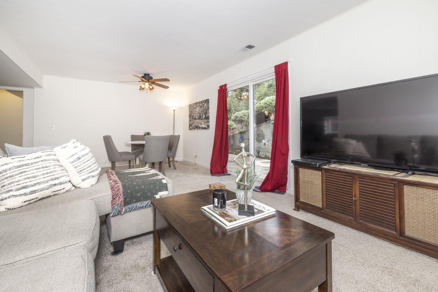 27975 Edgecliff Way Hayward, CA 94542 - Photo 37 of 58 a living room with furniture a flat screen tv and floor to ceiling window