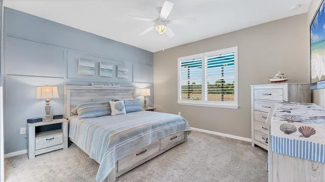 a bedroom with a bed and painting on the wall