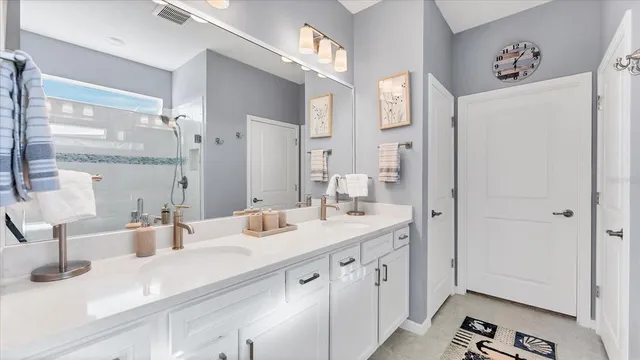 a bedroom with a bed a mirror and a window