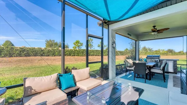 a view of a house with a yard potted plants and a table
