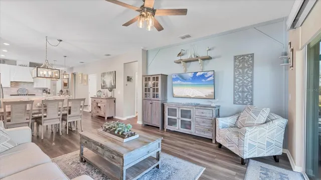 a living room with furniture and a kitchen view