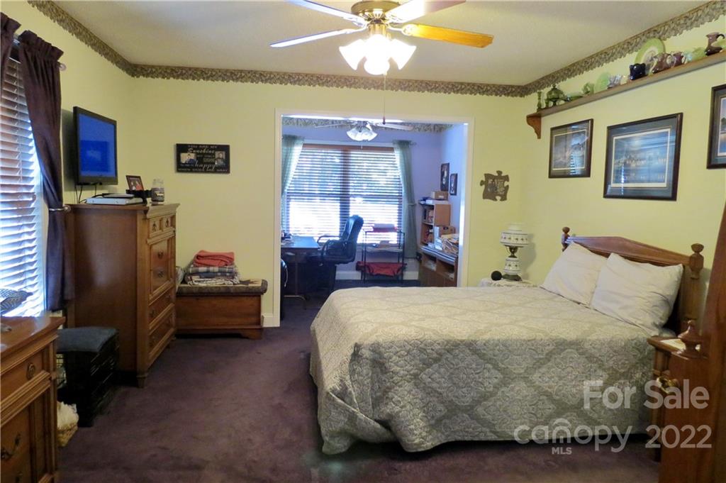 383 Maple Ridge Circle Salisbury, NC 28147 - Photo 18 of 36 a bedroom with a bed dresser and a flat tv screen