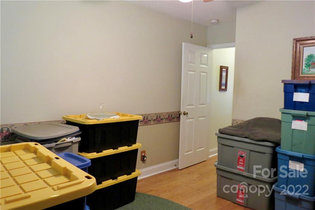 383 Maple Ridge Circle Salisbury, NC 28147 - Photo 29 of 36 a living room with furniture and a baby crib