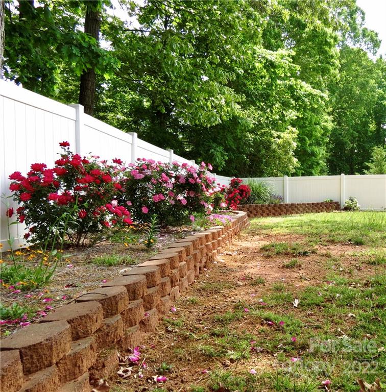 383 Maple Ridge Circle Salisbury, NC 28147 - Photo 8 of 36 a view of a garden with flowers and trees