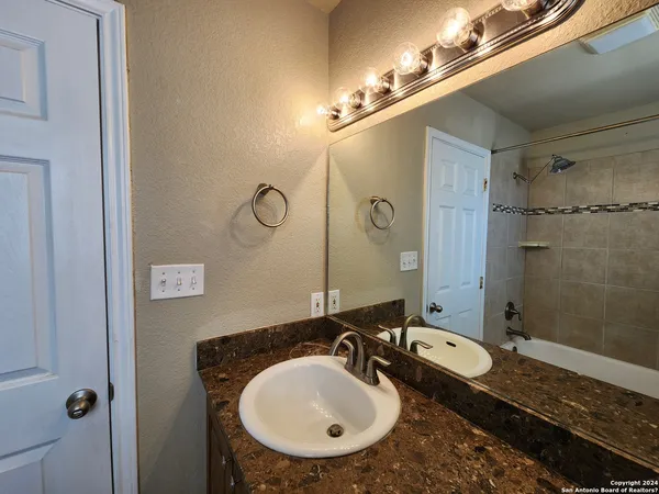 a bathroom with a sink and a mirror
