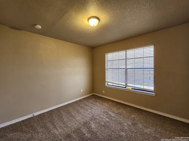 an empty room with a empty space and windows