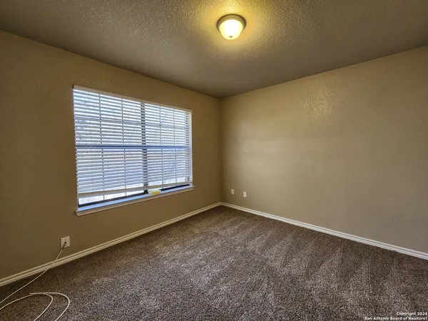 an empty room with a empty space and windows