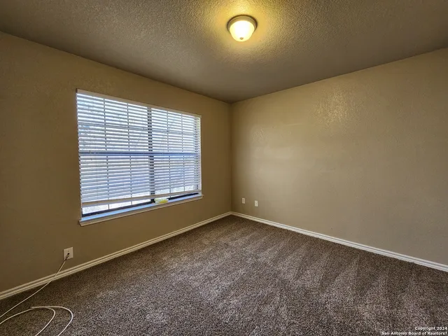 an empty room with a empty space and windows