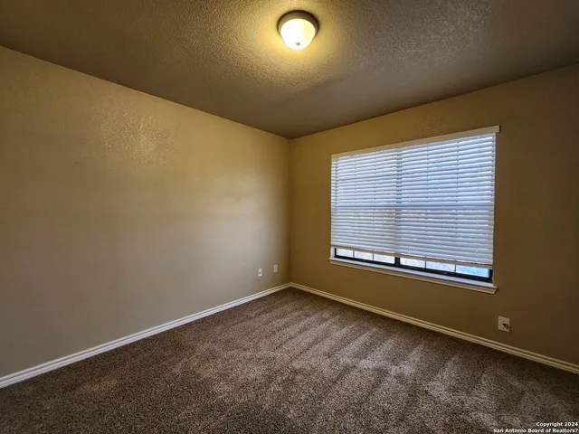 an empty room with a empty space and windows