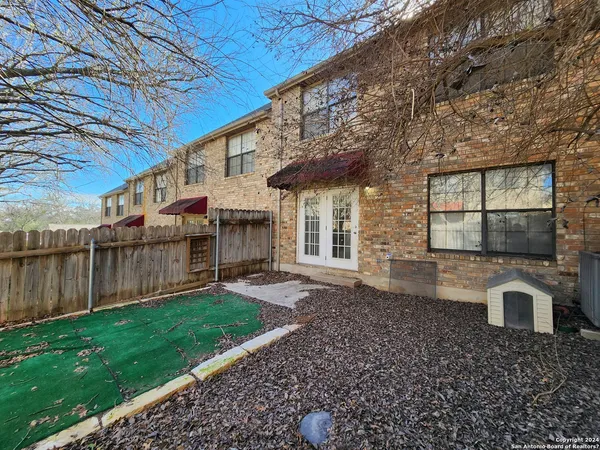 a view of a house with a yard and sitting area