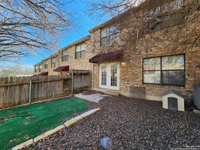 a view of a house with a yard and sitting area