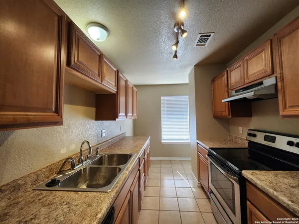 a kitchen that has a sink and a stove