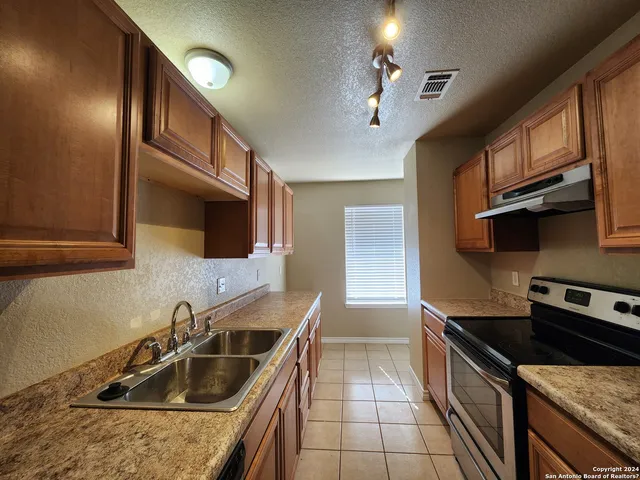 a kitchen that has a sink and a stove