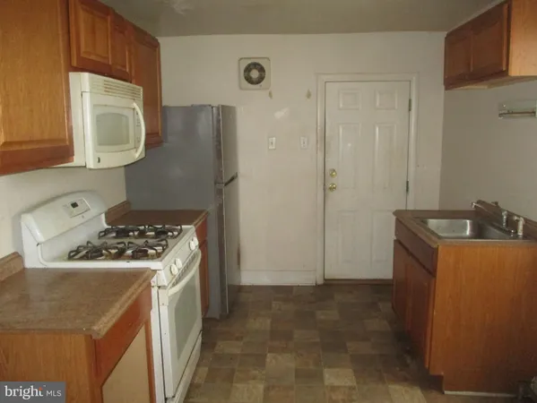 a kitchen with a stove and a refrigerator