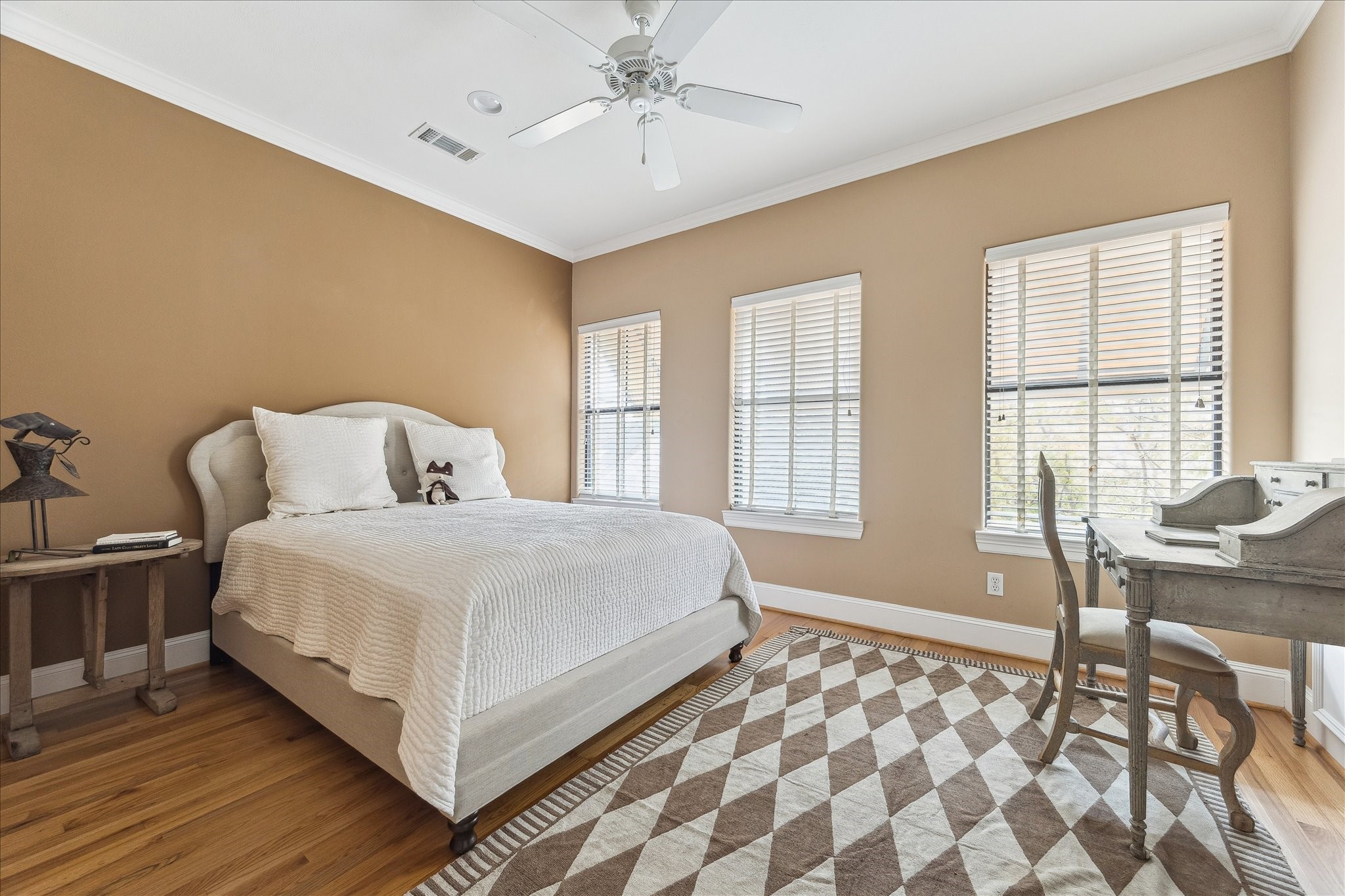 3515 Yupon Street Houston, TX 77006 - Photo 21 of 41 a bedroom with a bed and wooden floor