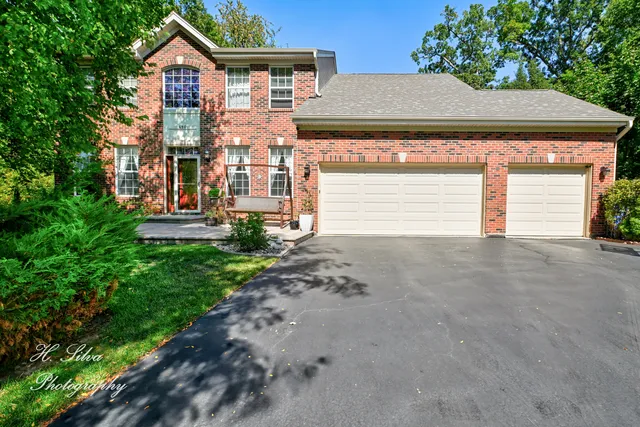a view of a house with a yard and garage
