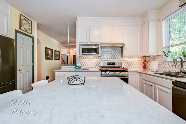 a kitchen with granite countertop cabinets stainless steel appliances and a sink