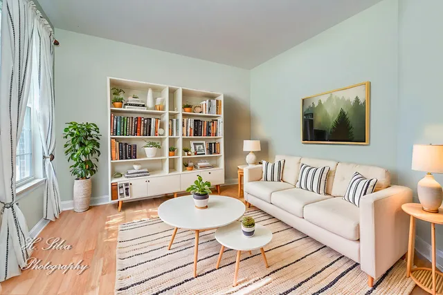 a living room with furniture and a book shelf