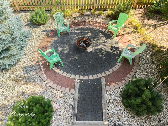 a view of backyard with plants and outdoor seating