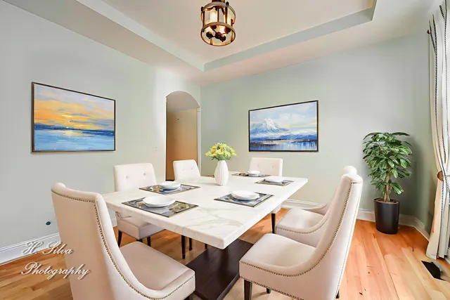 a dining room with furniture a potted plant and a chandelier