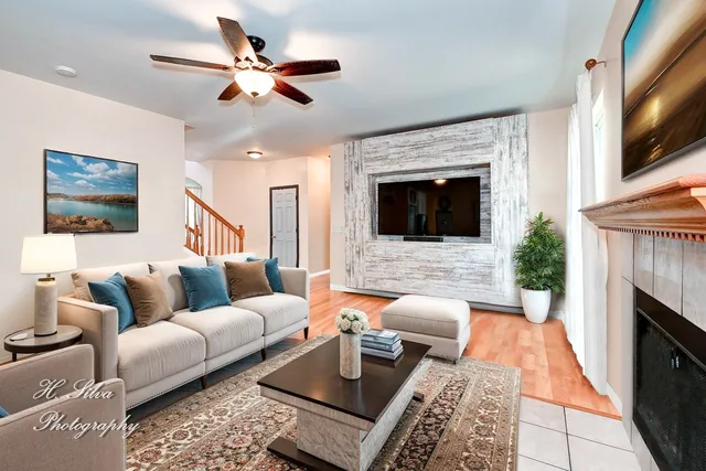 a living room with furniture a fireplace and a flat screen tv
